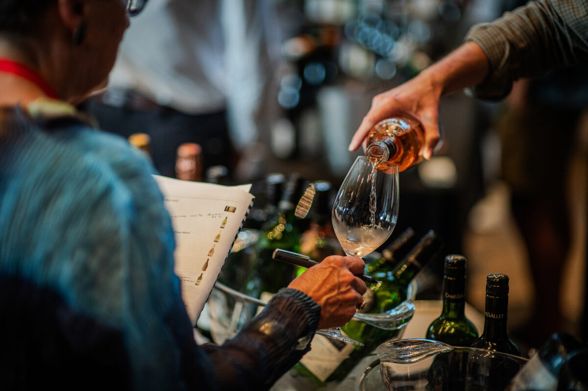 Trade tasting - wine glass being poured
